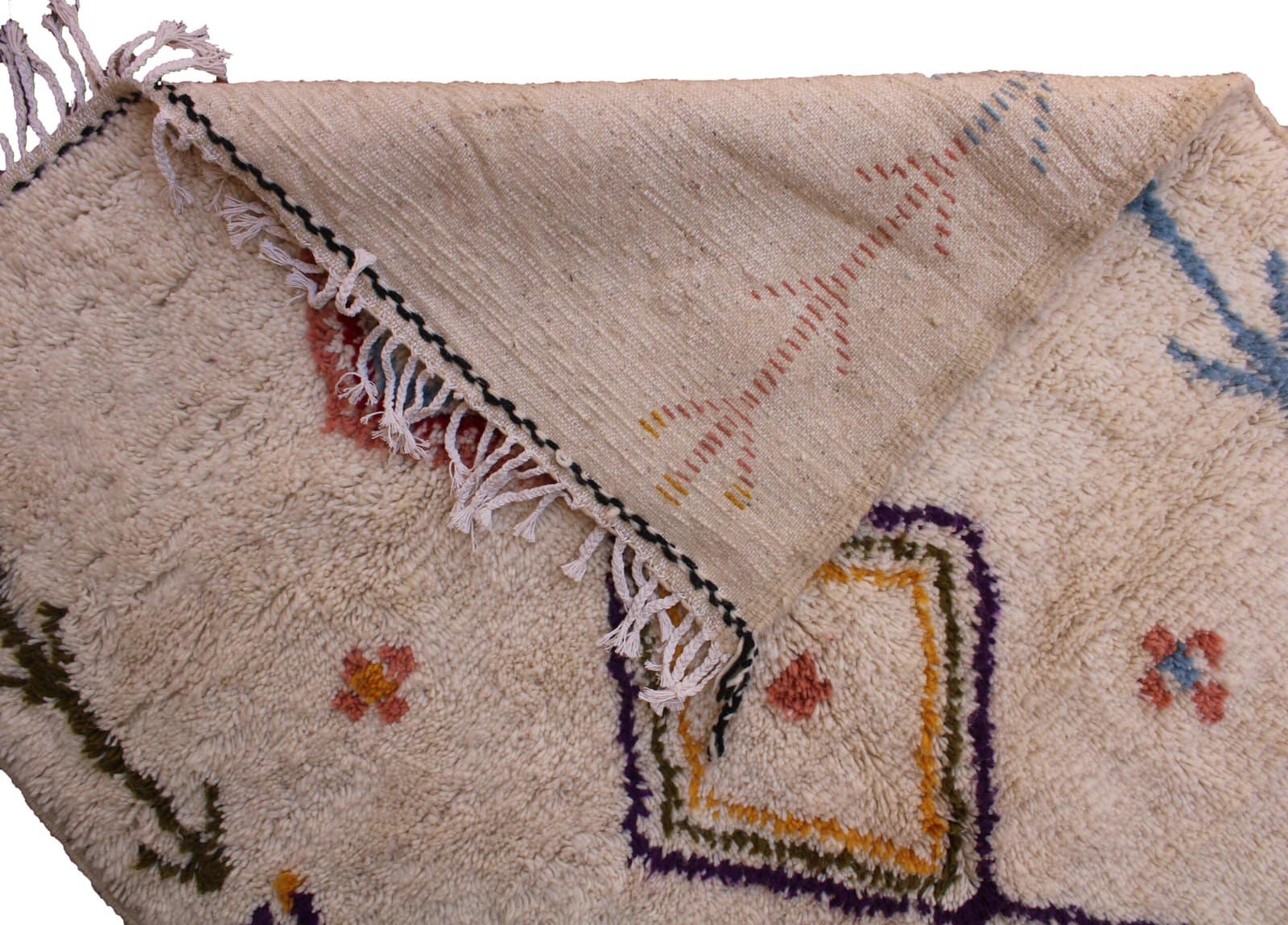 moroccan-wool-area-rug-ivory-with-colorful-motifs Corner detail showing plush high-pile wool and handcrafted weaving quality.