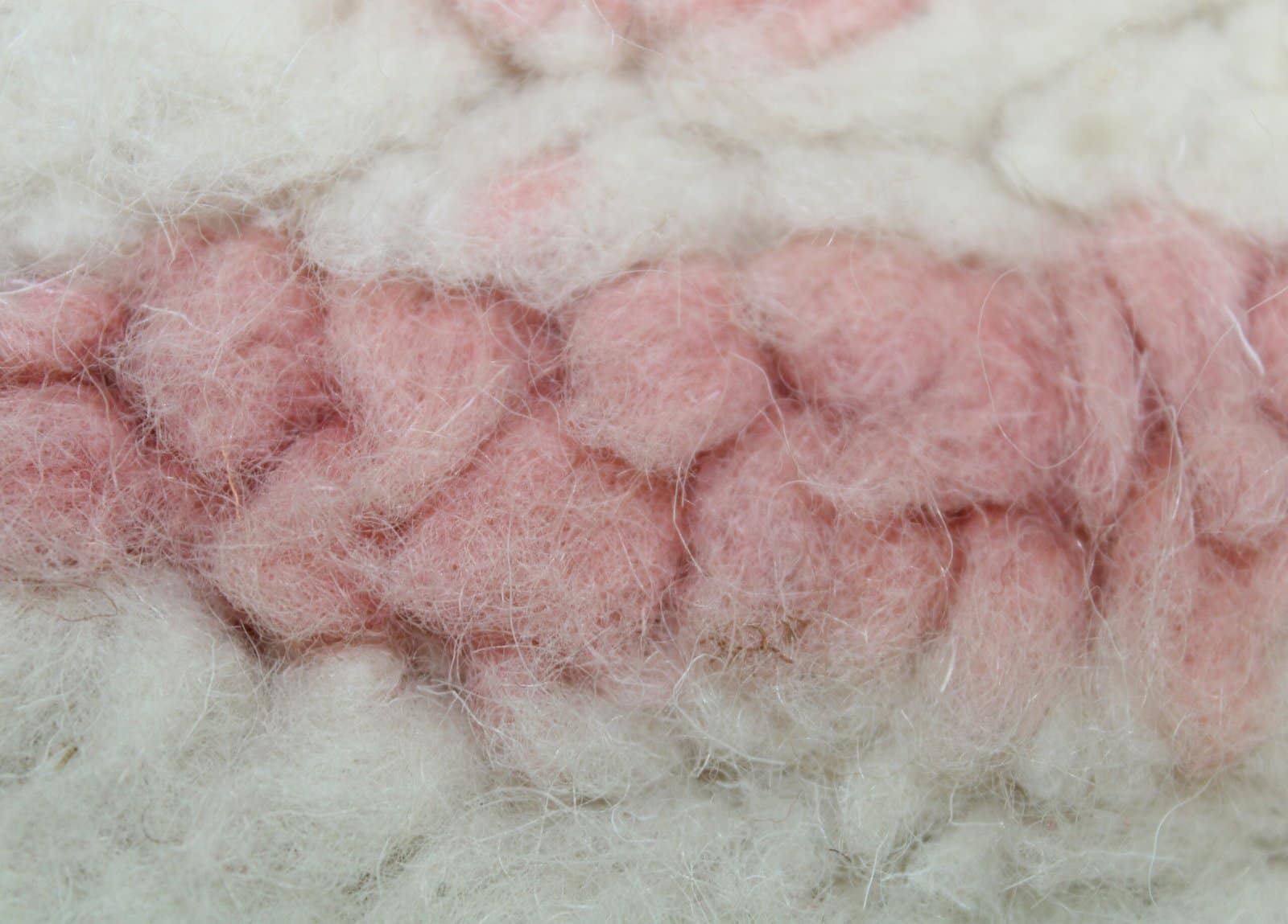 artisan-made-moroccan-wool-rug A traditional Moroccan handwoven rug with geometric pink details. Wool details.