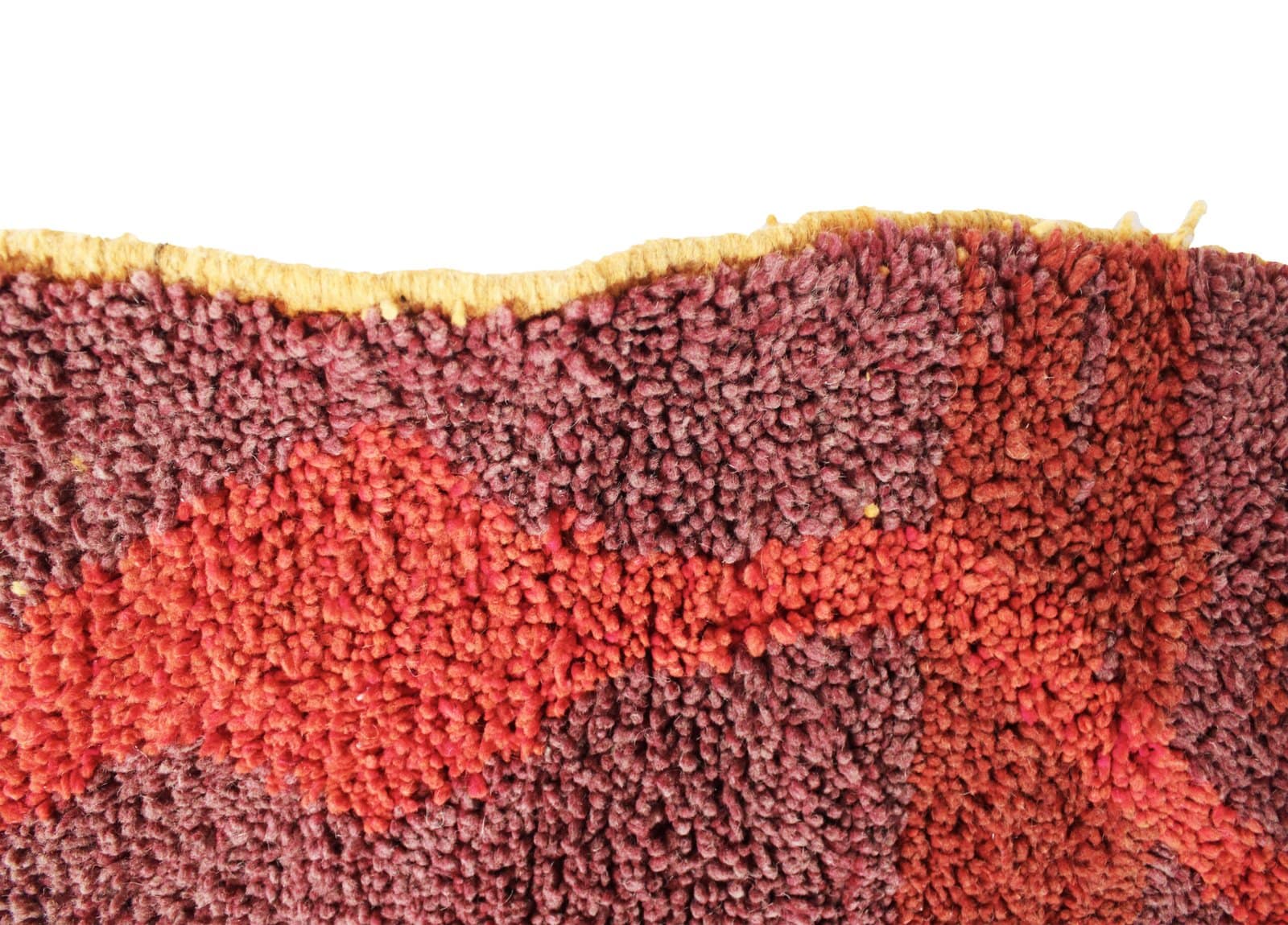 authentic-moroccan-wool-rug-modern-tribal Close-up view of a handmade Moroccan Berber rug showing red and green abstract patterns and thick wool texture.