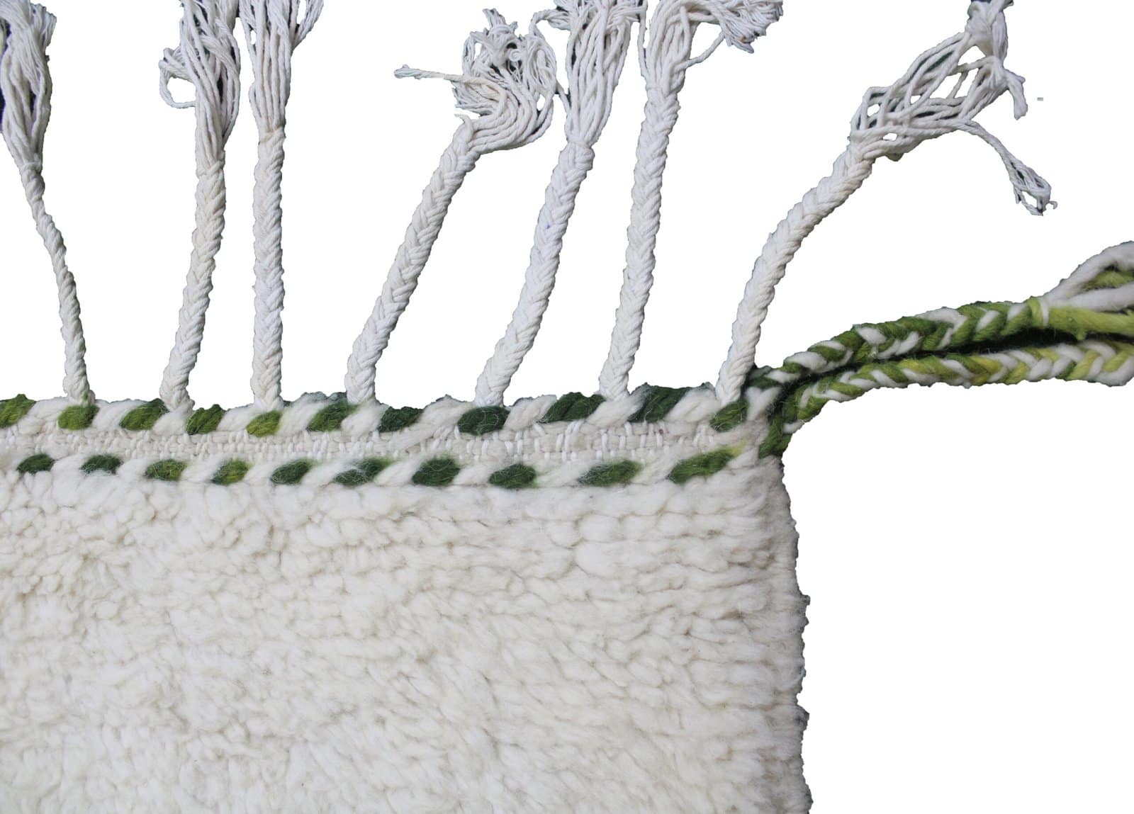 beni-ourain-wool-rug Corner detail of white Beni Ourain rug with green, brown, and yellow patterns.