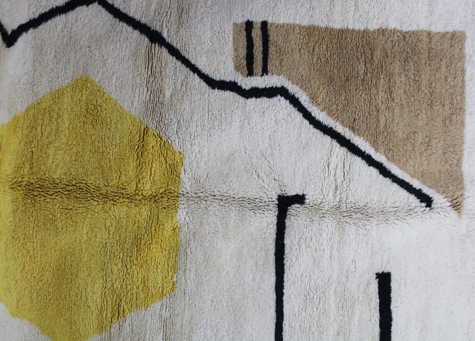 custom-moroccan-handmade-area-rug Wide shot of contemporary Berber area rug with bold yellow centerpiece.