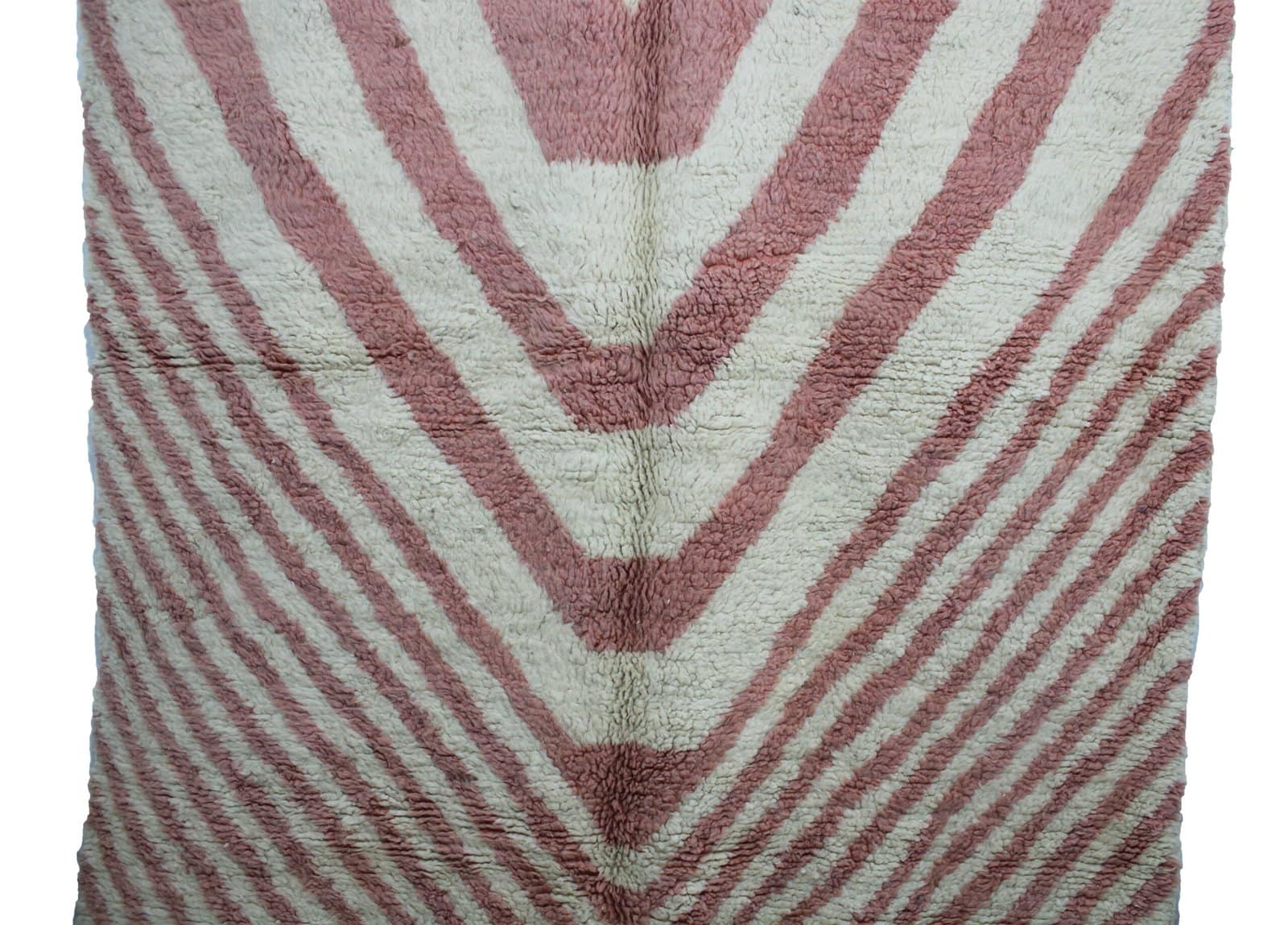 handmade-berber-wool-rug-pink-chevron copy Artisan-made Moroccan area rug with pink and cream V-shaped chevron design.