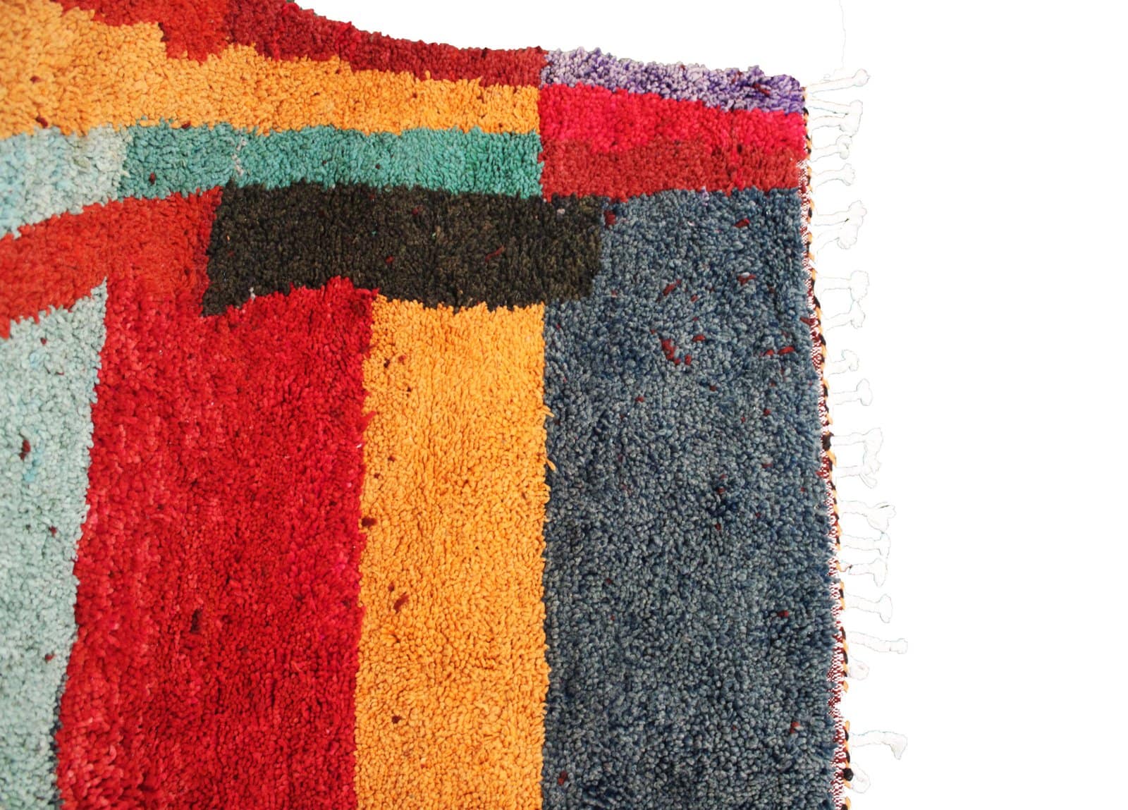 modern-moroccan-geometric-shag-rug Upper left detail featuring orange and green geometric shapes with layered stripes
