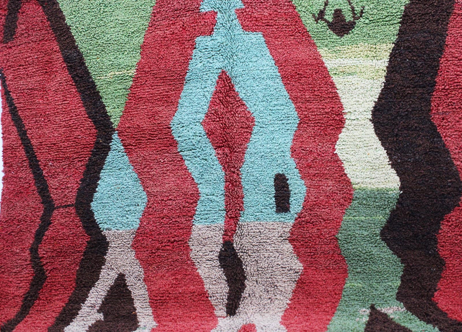 authentic-moroccan-berber-rug-red-base-design Partial close-up of rug pattern focusing on central shapes