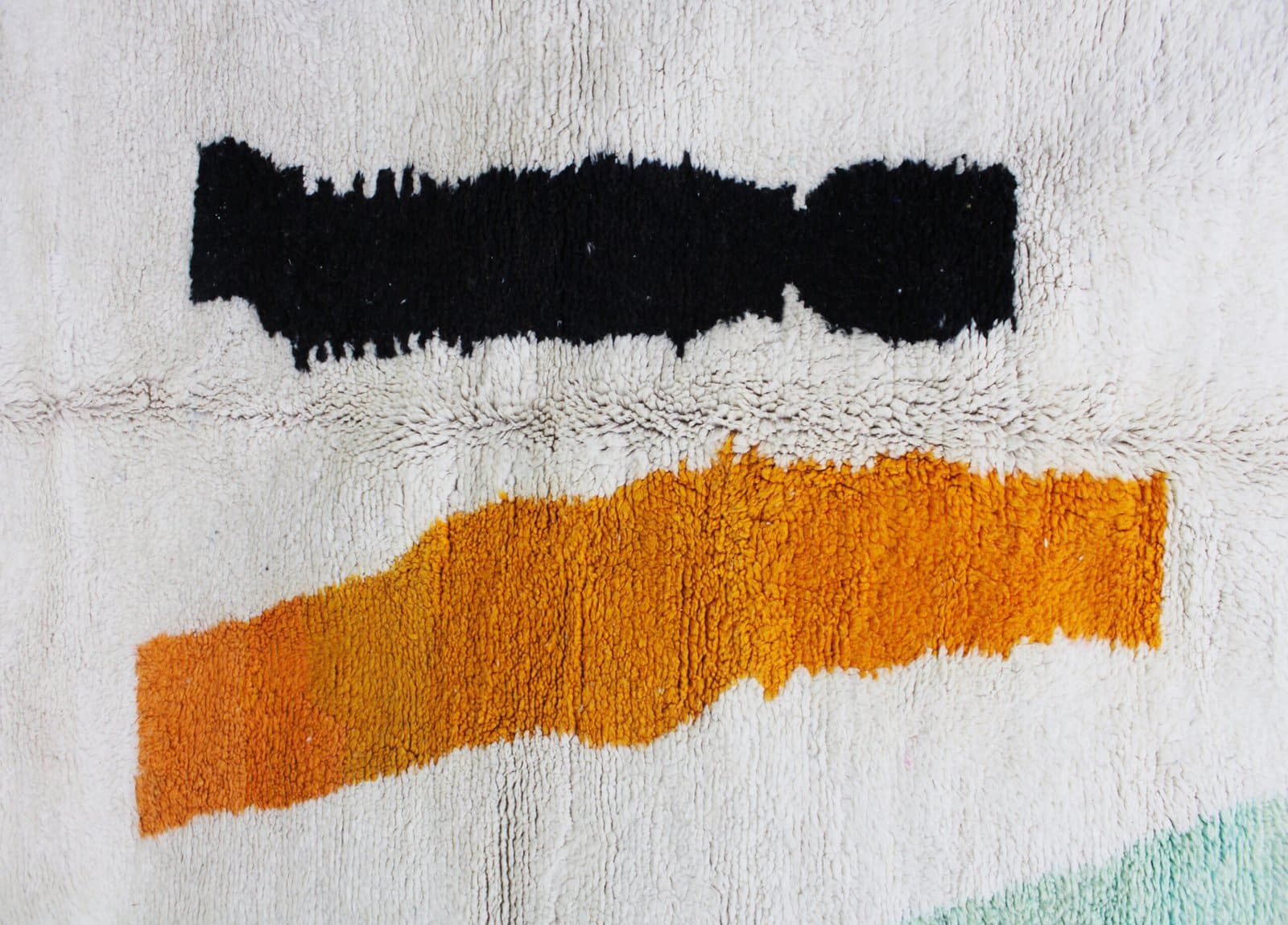 beni-ourain-wool-rug-minimalist-abstract-style.jpg Top view of handmade rug showing full composition and color balance