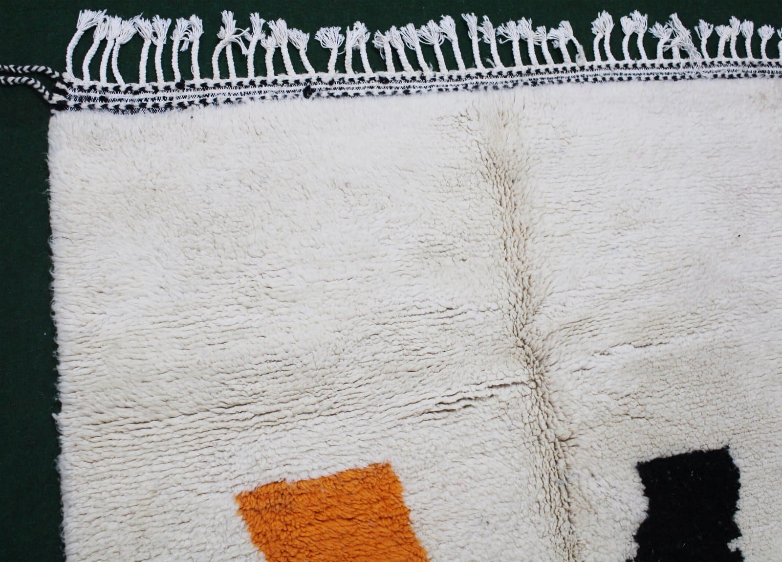 handmade-wool-rug-moroccan-abstract-art-design.jpg Close-up view of Moroccan wool rug showing soft texture and detailed pattern