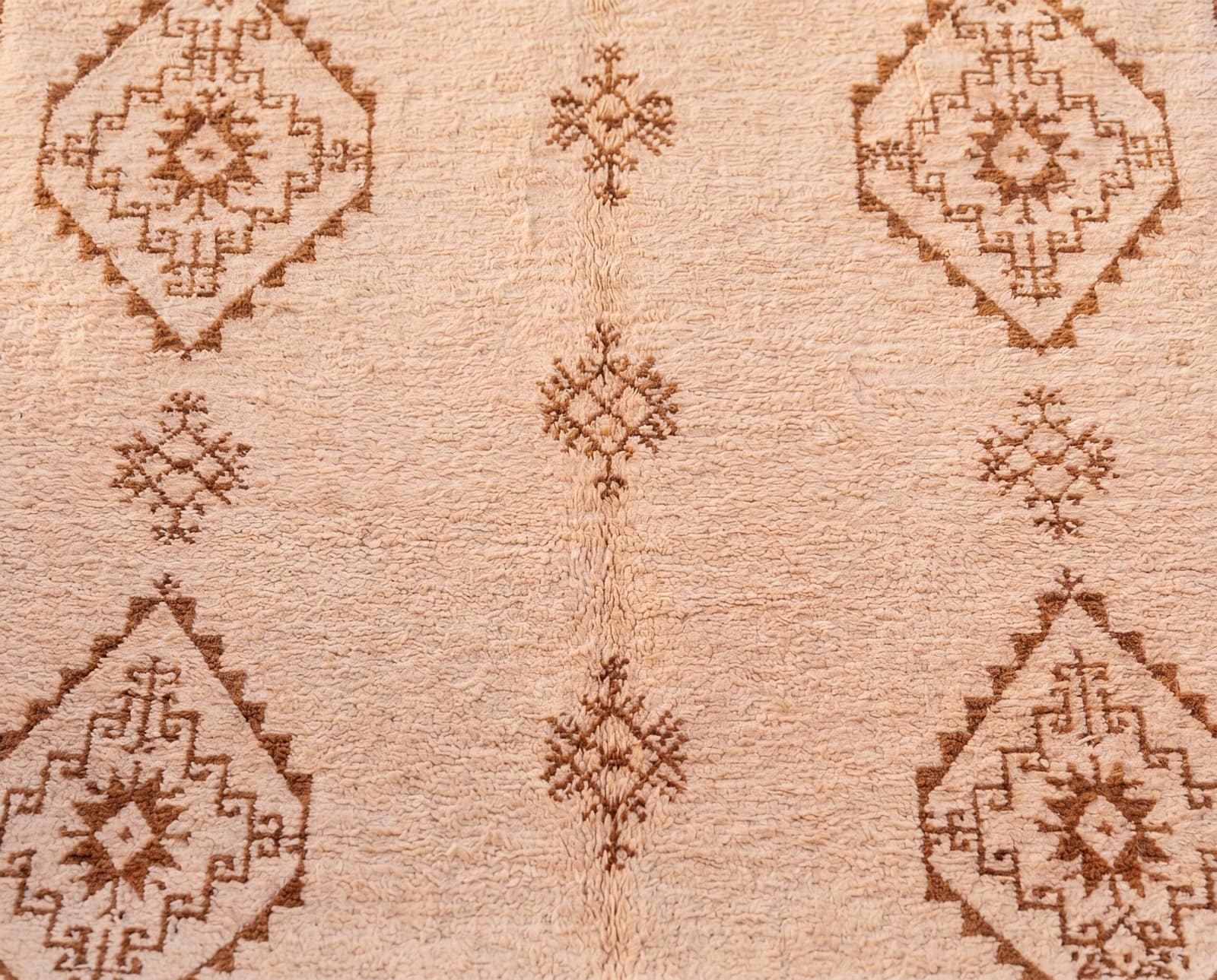 luxury-moroccan-berber-rug-neutral-living-room Handmade Moroccan Wool Rug, Plush creamy wool base with brown geometric motifs