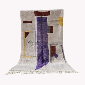 Full view of a handmade Moroccan Berber rug with a cream base and purple vertical stripe, displayed upright.