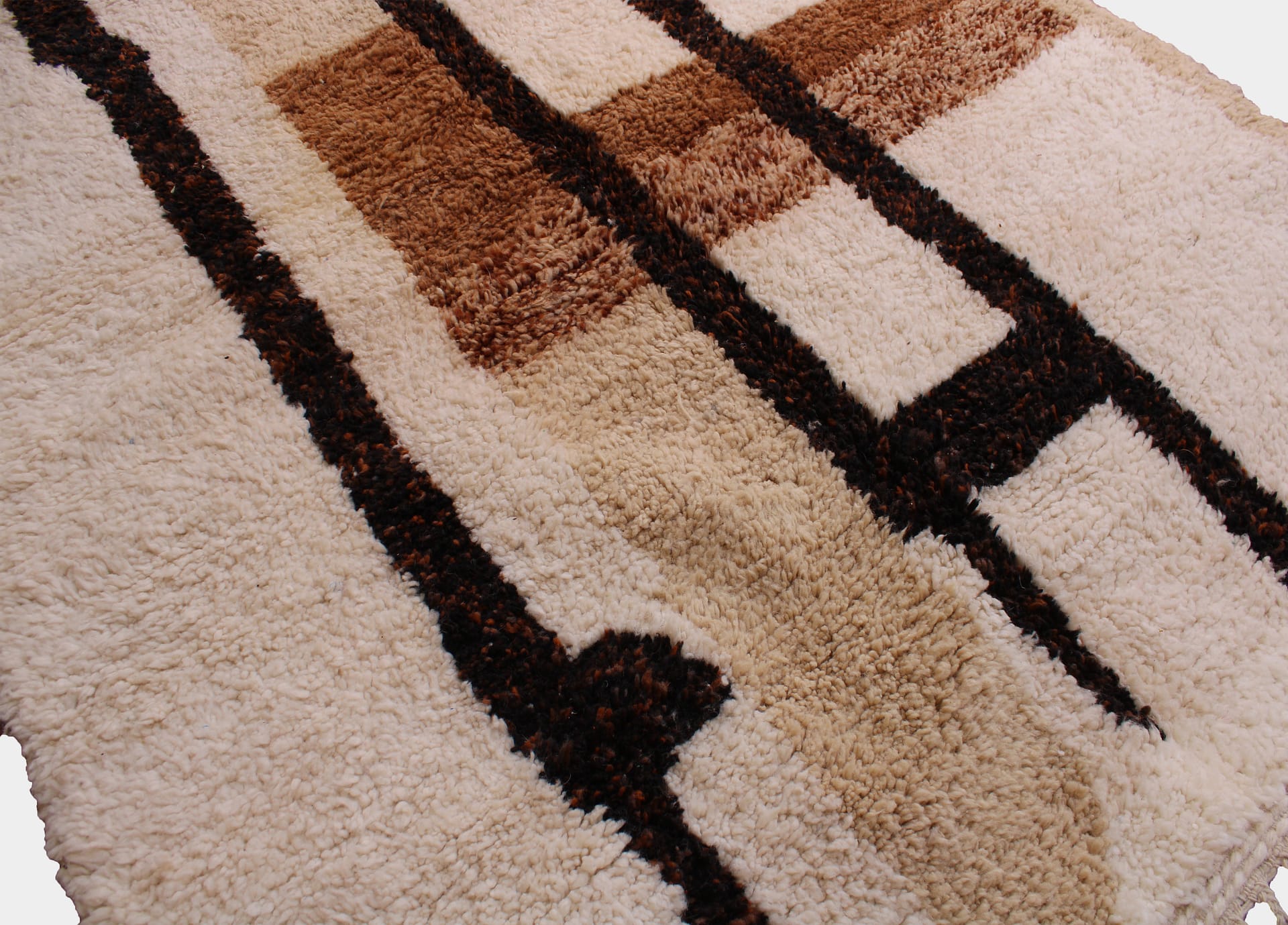 brown-moroccan-beni-ourain-carpet Brown Moroccan Berber rug styled in modern interior angled view angled view