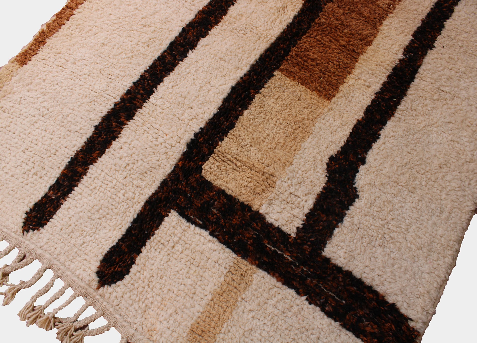 brown-handwoven-moroccan-rug Handwoven brown Moroccan wool carpet with fringe detail angled view