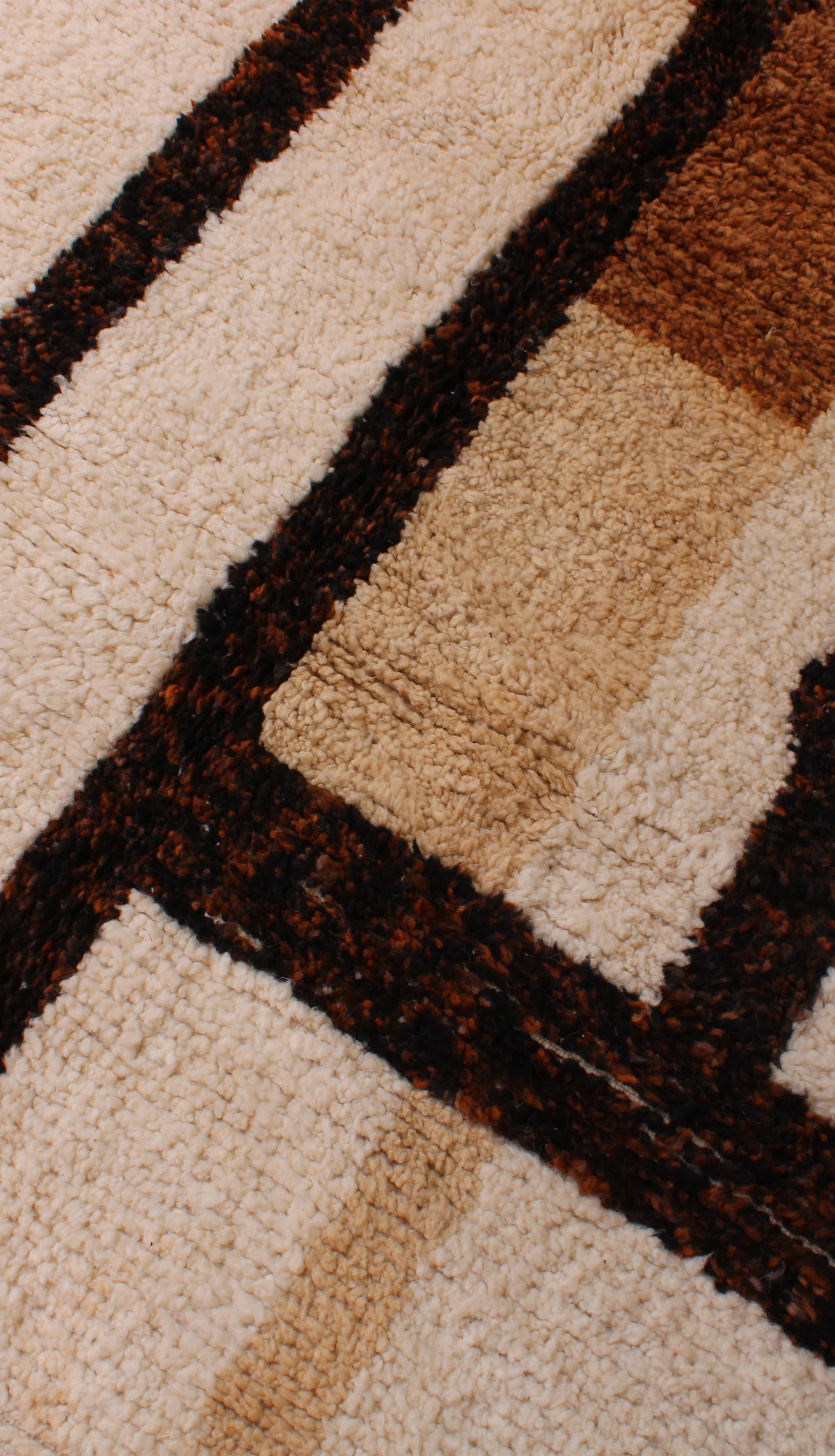 brown-handwoven-moroccan-rug Handwoven brown Moroccan wool carpet with fringe detail angled view